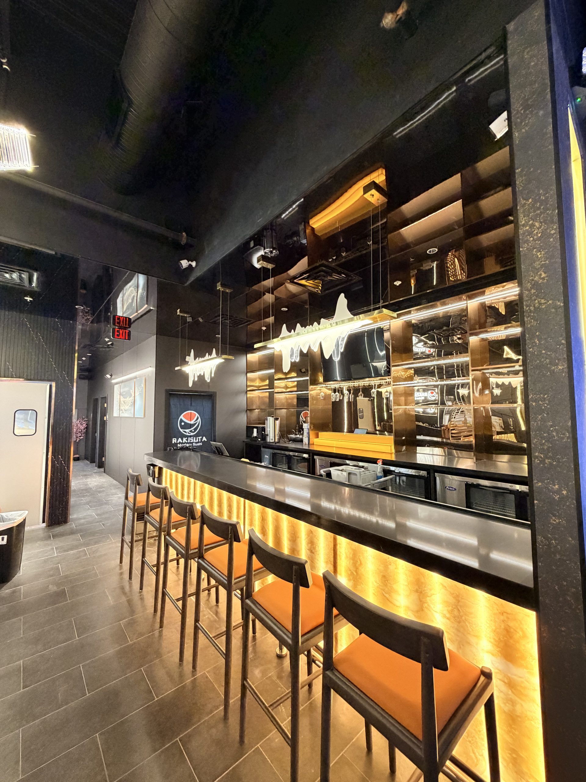 Chic indoor dining space with black furniture at Rakisuta Modern Sushi, Japanese Restaurant in Rockledge